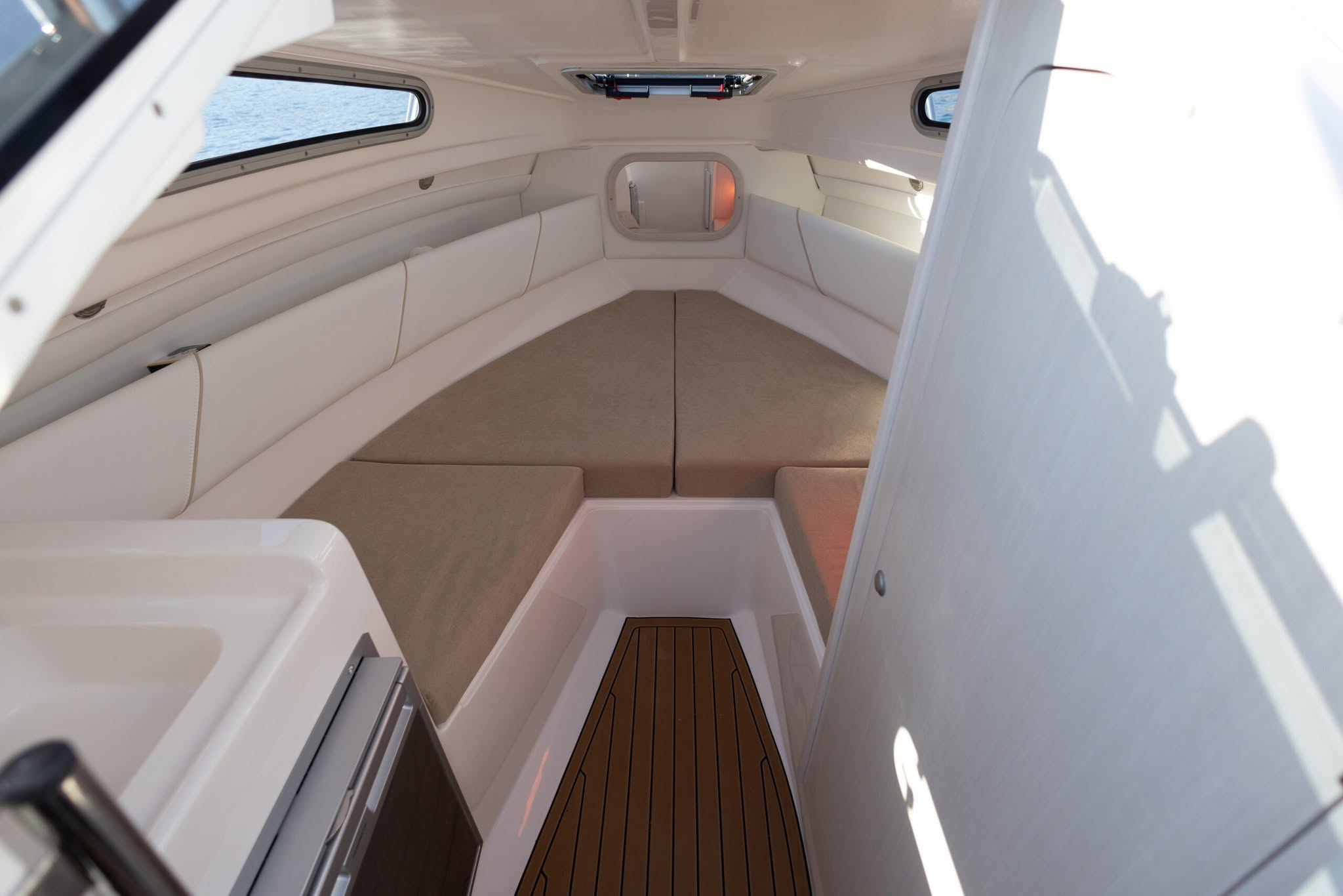 Cabin interior with upholstered berth